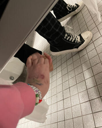 me holding hands with my girlfriend under the bathroom stall